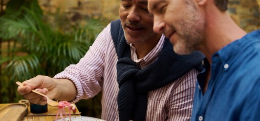 Middle aged men eating in garden