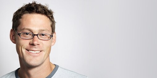 Young man wearing glasses smiling