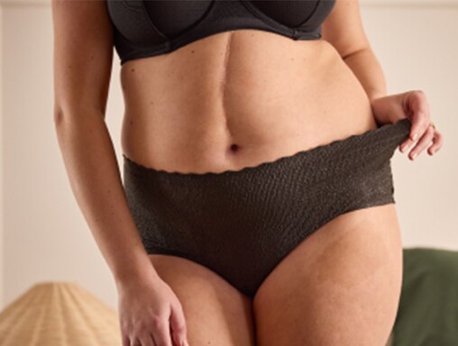 Woman wearing TENA Silhouette black incontinence underwear