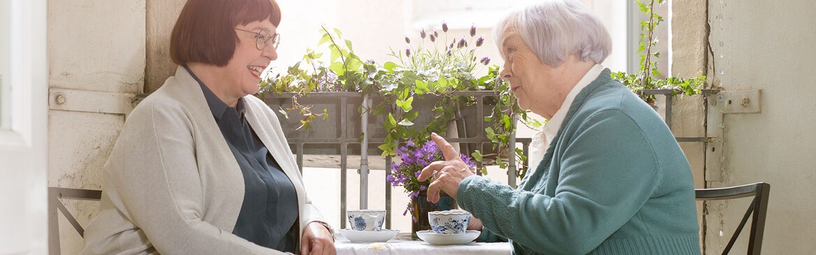 Two women having coffee on the balcony