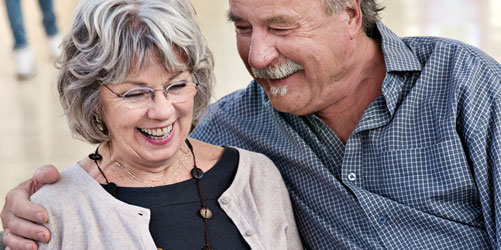 Old couple sitting on sofa